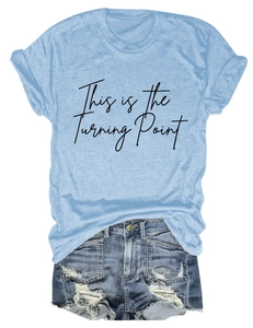 Detail of light blue crew neck T-shirt with text print and distressed denim shorts