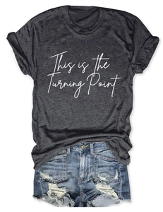 Detailed flat lay of dark gray short sleeve T-shirt with white text and denim shorts