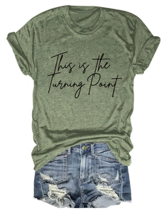 Detail of green round neck T-shirt with 'This is the Turning Point' text and denim shorts