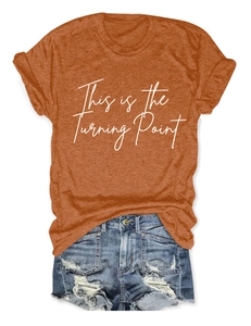 Detailed flat lay of rust orange cotton t-shirt with This is the Turning Point print