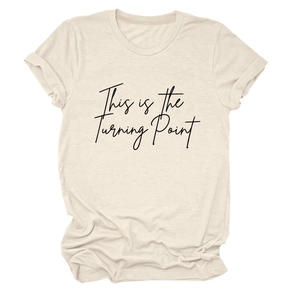 Detail of soft cream cotton T-shirt showing sleeve cuff and 'This is the Turning Point' print