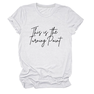 Close-up of white T-shirt featuring 'This is the Turning Point' text and rolled cuffs
