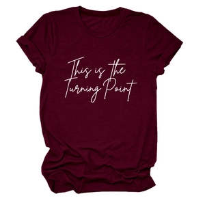 Close-up of burgundy cotton T-shirt featuring 'This is the Turning Point' white script text