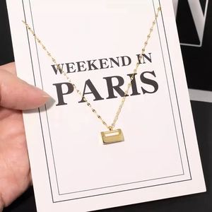 Solid gold lock pendant necklace with a white inlay on a wave chain for women