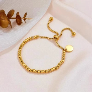 Adjustable gold bead chain bracelet with round charm and sliding toggle clasp for women