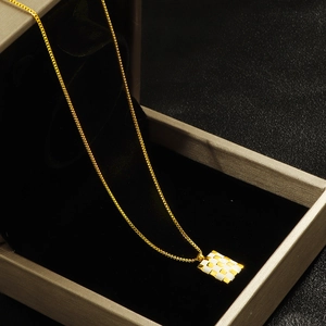 Square checkered 18k gold plated stainless steel necklace on black jewelry box