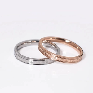 Matching couple rings in silver and rose gold steel with romantic engraved letters