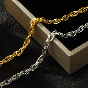 Thick gold and silver twisted chain bracelets set on a luxury black velvet jewelry box