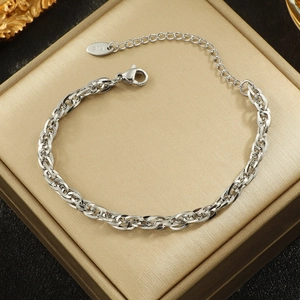Silver thick link chain bracelet with K18 engraved charm on a golden jewelry box