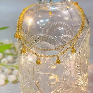 Golden titanium steel double-layer bracelet with lily of the valley pendants on glass bottle
