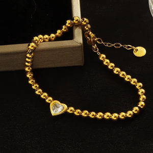 Elegant gold beaded stainless steel bracelet featuring a sparkling heart zircon pendant
