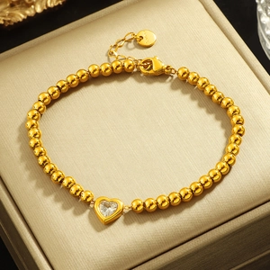 Beaded titanium steel bracelet with heart zircon pendant on a golden jewelry box