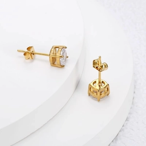 Elegant gold four-prong zircon stud earrings with classic crown settings on white display