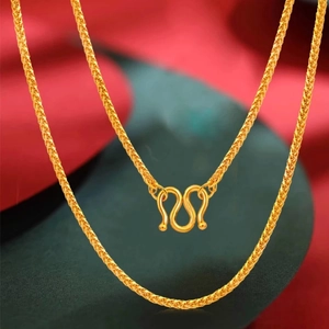 Macro detail of golden wheat chain texture with traditional secure M-clasp closure