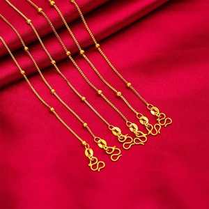 Five gold titanium steel bead necklaces on red silk background with S-shaped clasps