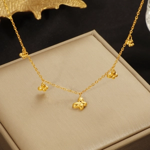 Polished gold butterfly pendant necklace for women on a champagne jewelry box background