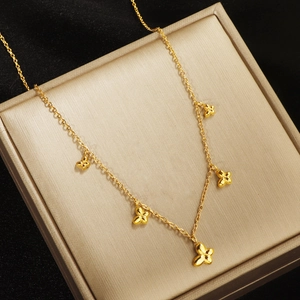 Polished gold butterfly necklace with five 3D charms on a premium display box