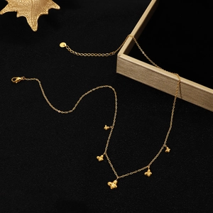 Polished gold butterfly pendant necklace with five charms on delicate cable chain