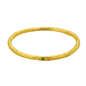 Vintage gold relief bangle with ornate filigree pattern and green gemstone center