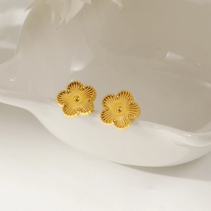 Golden four-leaf clover stud earrings with textured petals and beaded edges