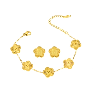 Golden stainless steel jewelry set featuring clover bracelet and matching flower earrings