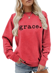 Detail of red crewneck sweatshirt featuring black grace text and small heart print