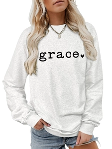 Close-up of grace lettering and heart print on grey crewneck sweatshirt fabric