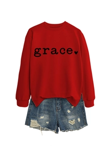 Detail of red crew neck sweatshirt with grace heart print and casual denim shorts