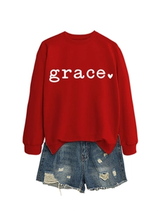 Flat lay of a red grace heart print sweatshirt with blue distressed denim shorts
