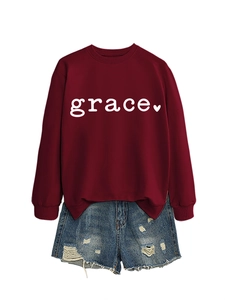 Detail of burgundy heart print sweatshirt and distressed denim shorts casual set