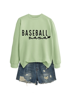 Flat lay of a light green Baseball Mama sweatshirt paired with distressed denim shorts