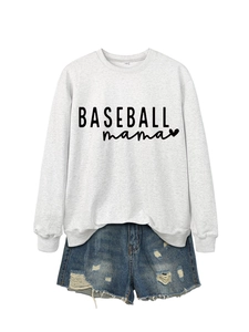 Flat lay detail of a white baseball mama sweatshirt paired with distressed denim shorts