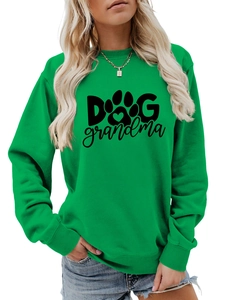 Detail of green crewneck sweatshirt featuring Dog Grandma text and paw print logo