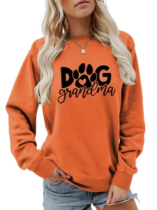 Detail of ribbed cuffs and Dog Grandma print on bright orange crewneck sweatshirt