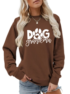 Close-up of the white Dog Grandma text and paw print on the brown crewneck sweatshirt