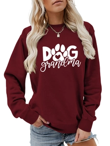 Close-up of Dog Grandma text and heart paw print on burgundy crewneck sweatshirt