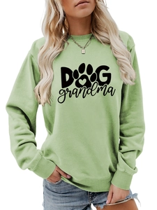Detail view of sage green sweatshirt featuring DOG grandma text with heart paw print