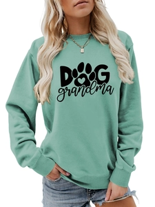 Detail of mint green sweatshirt featuring black Dog Grandma text and heart paw print logo