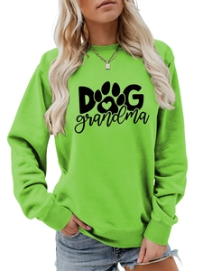 Detail of green crewneck sweatshirt featuring Dog Grandma text and paw print design