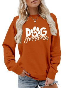 Close-up of burnt orange Dog Grandma sweatshirt with white paw print and heart detail
