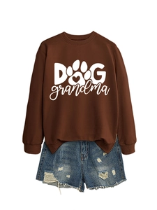 Detail of Dog Grandma sweatshirt with paw print design and distressed denim shorts
