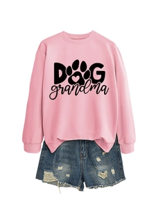 Close-up of pink crewneck sweatshirt with Dog Grandma print and distressed denim shorts