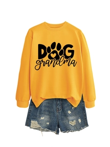 Flat lay of yellow long-sleeve sweatshirt with Dog Grandma print and ripped denim shorts