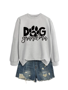 Flat lay of light grey sweatshirt with Dog Grandma print paired with ripped denim shorts