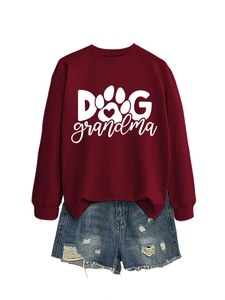 Close-up of burgundy crewneck sweatshirt with Dog Grandma print and denim shorts