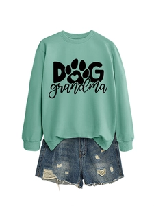 Flat lay of Dog Grandma mint green sweatshirt with blue ripped denim shorts and heart paw print