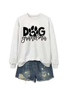 Flat lay of Dog Grandma sweatshirt paired with distressed denim shorts on white background