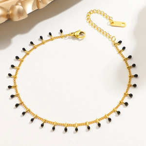 Golden titanium steel anklet with black beads and fringe tassels for women