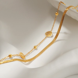 Double-layered gold snake chain bracelet with Tree of Life charm and beaded details