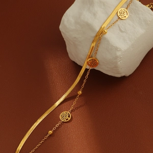 Gold double-layer herringbone chain bracelet featuring a hollow Tree of Life charm pendant